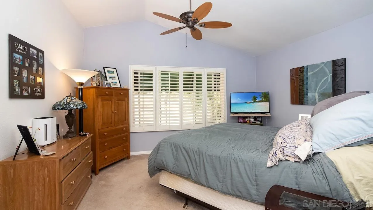 14140 Carmel Ridge Road San Diego, CA 92128 - Photo 10 of 17 a bedroom with a bed dresser and a window