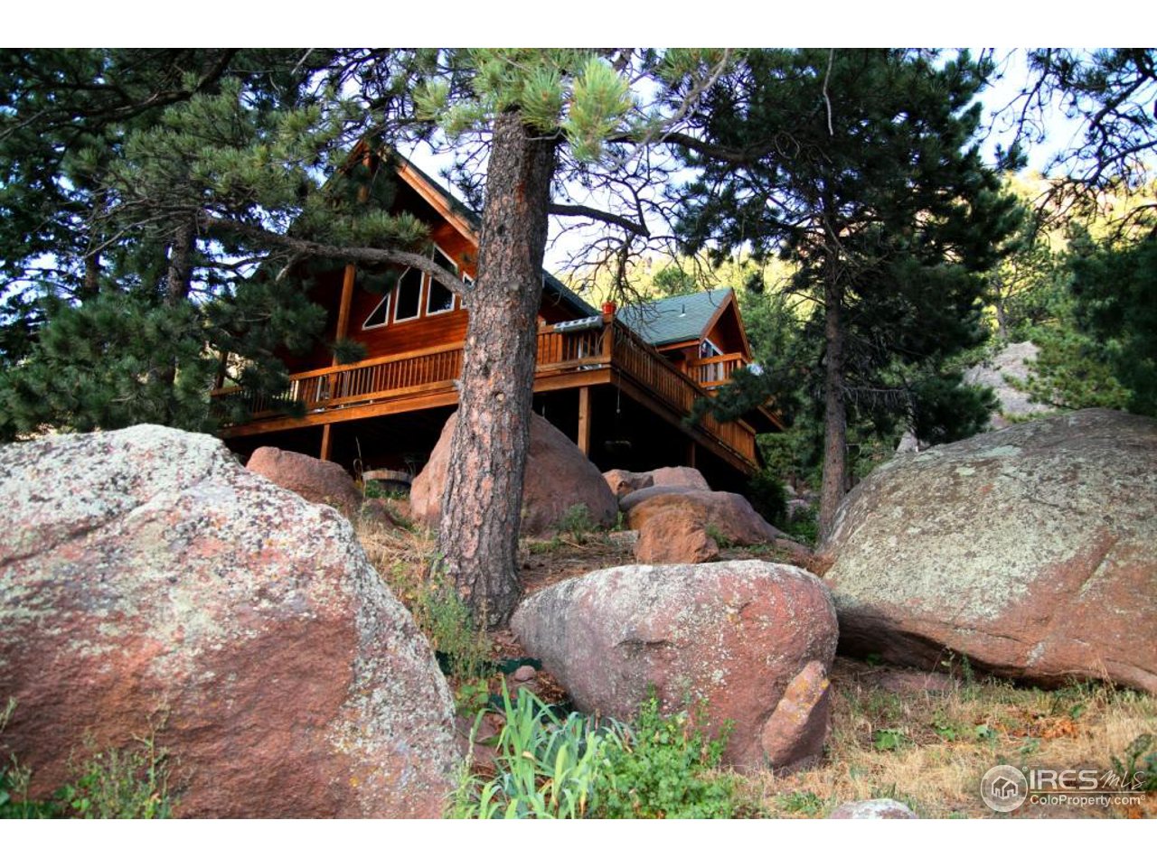 164 Button Rock Road Lyons, CO 80540 - Photo 1 of 23 a backyard of a house with table and chairs