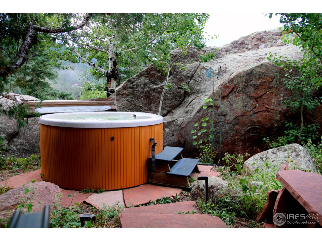 164 Button Rock Road Lyons, CO 80540 - Photo 23 of 23 a view of a backyard with furniture and a garden