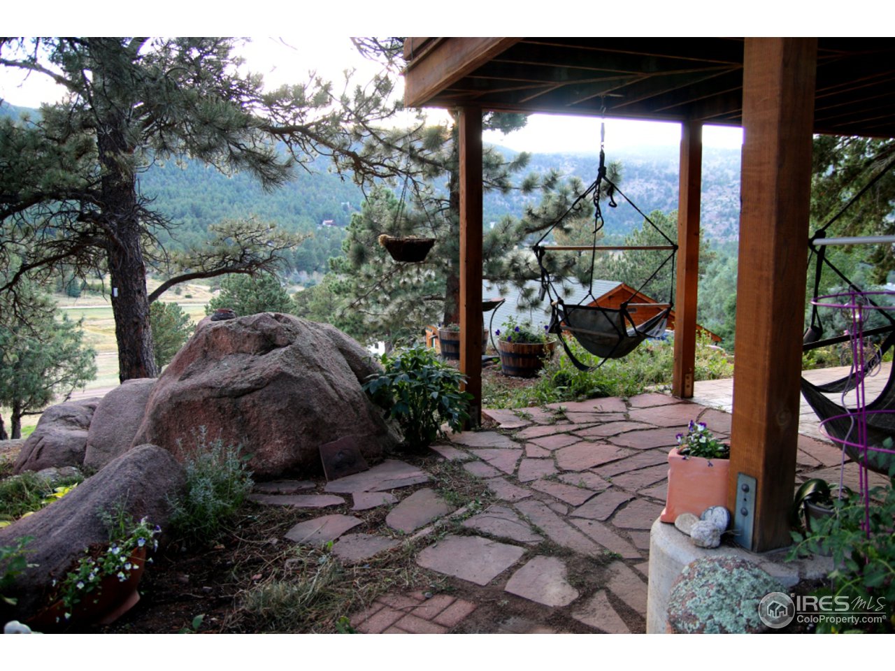 164 Button Rock Road Lyons, CO 80540 - Photo 5 of 23 a view of a backyard with potted plants and large tree