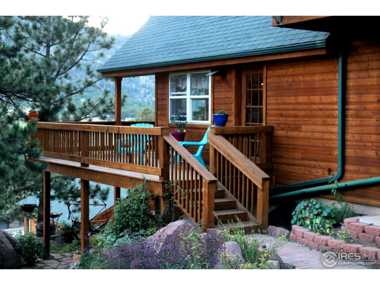 164 Button Rock Road Lyons, CO 80540 - Photo 8 of 23 a view of a house with a yard and deck
