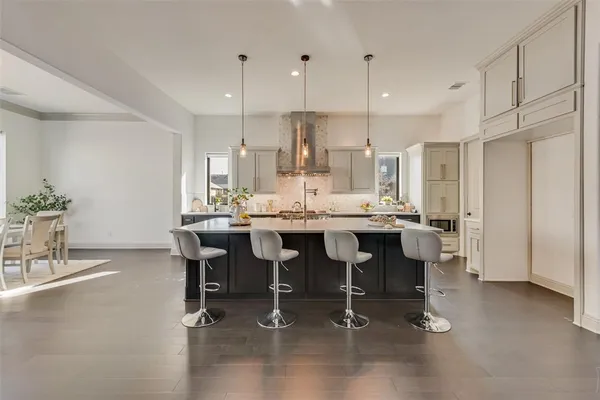a large kitchen with a table and chairs