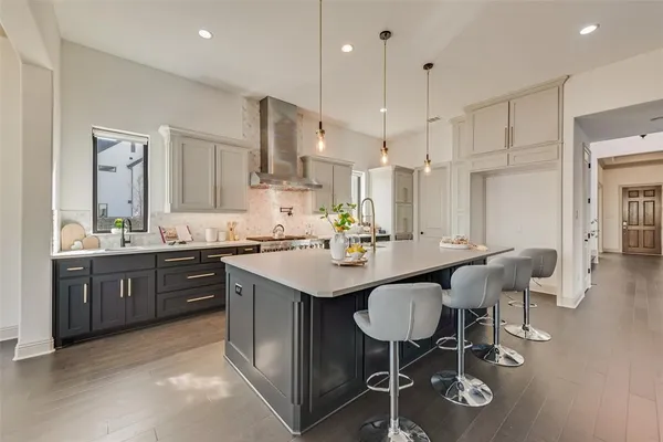 a kitchen with stainless steel appliances kitchen island granite countertop a sink and chairs