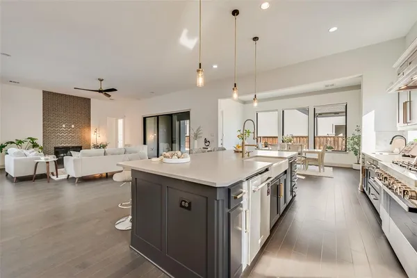 a kitchen with sink stove and cabinets