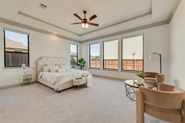 a spacious bedroom with a bed and a couch