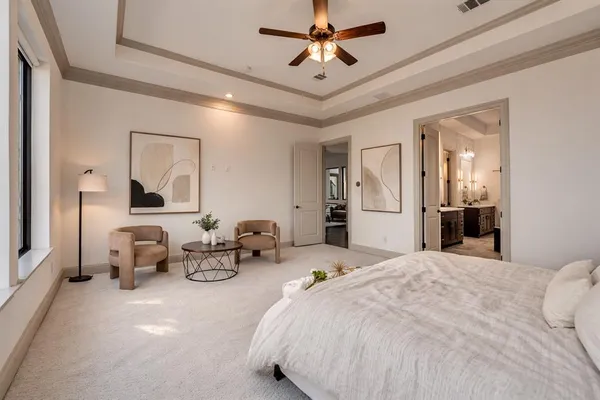 a bedroom with furniture and large mirror