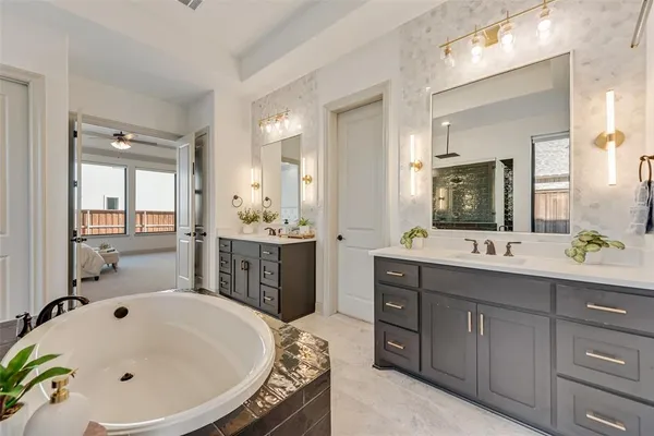 a bathroom with a tub sink and mirror