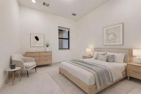 a bedroom with a bed and a chair