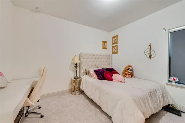 a bed room with a bed and a chair