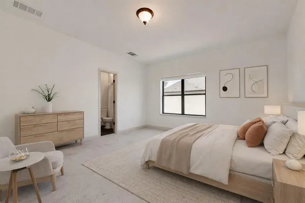 a bedroom with a bed and a window