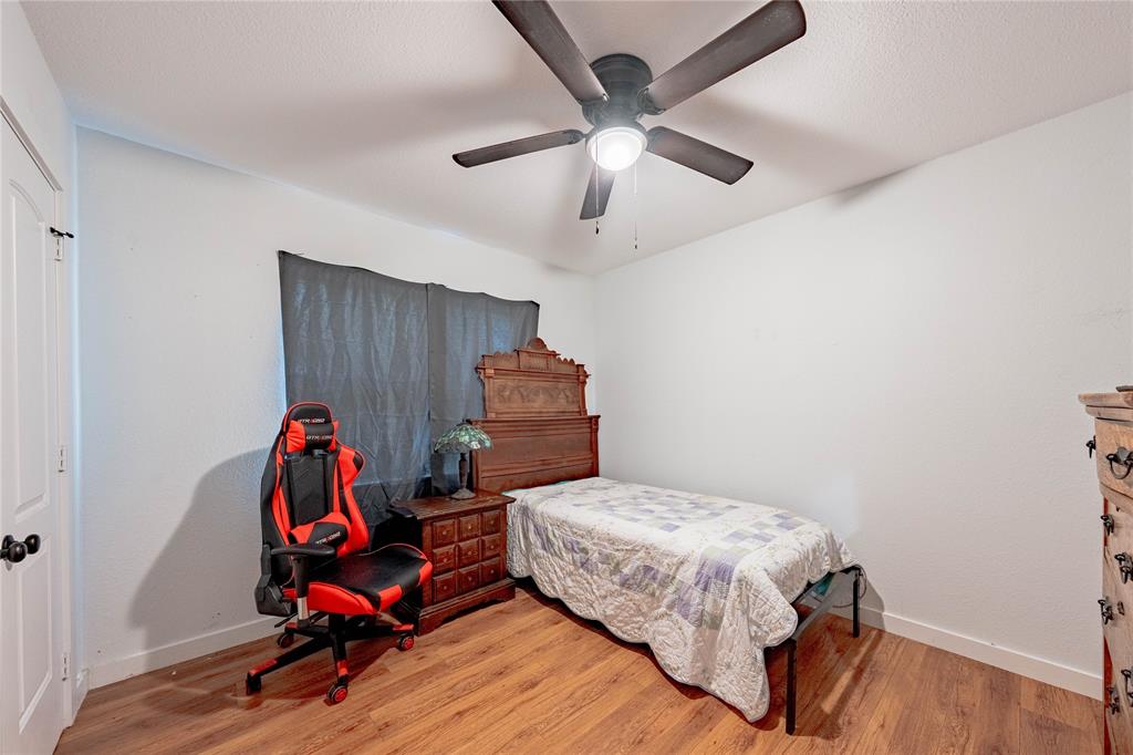 603 Mosley Road Athens, TX 75751 - Photo 8 of 15 a bedroom with a bed and wooden floor