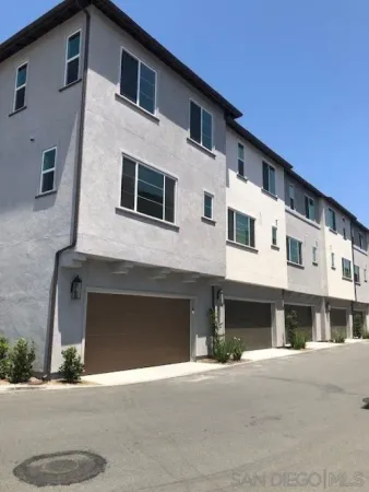 a front view of a house with a road