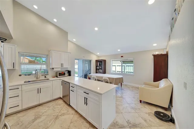 a large white kitchen with cabinets