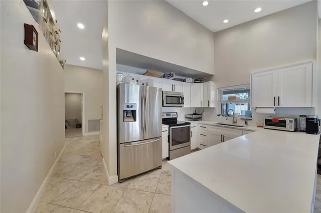 a kitchen with refrigerator and cabinets