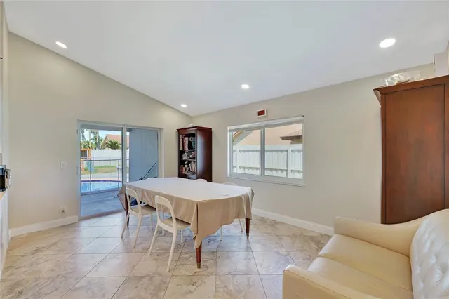 a dining room with furniture and window