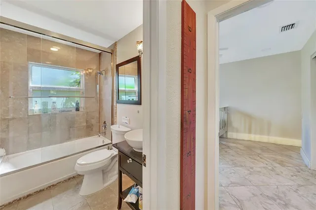 a bathroom with a toilet a sink and shower