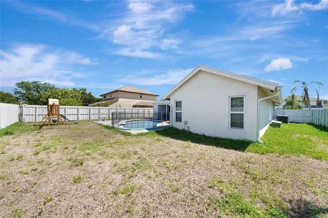 a view of a house with backyard and sitting area