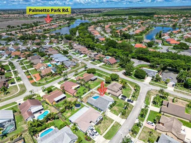 an aerial view of a house with garden space and street view