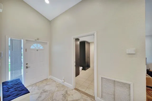 a view of a hallway with closet and bathroom