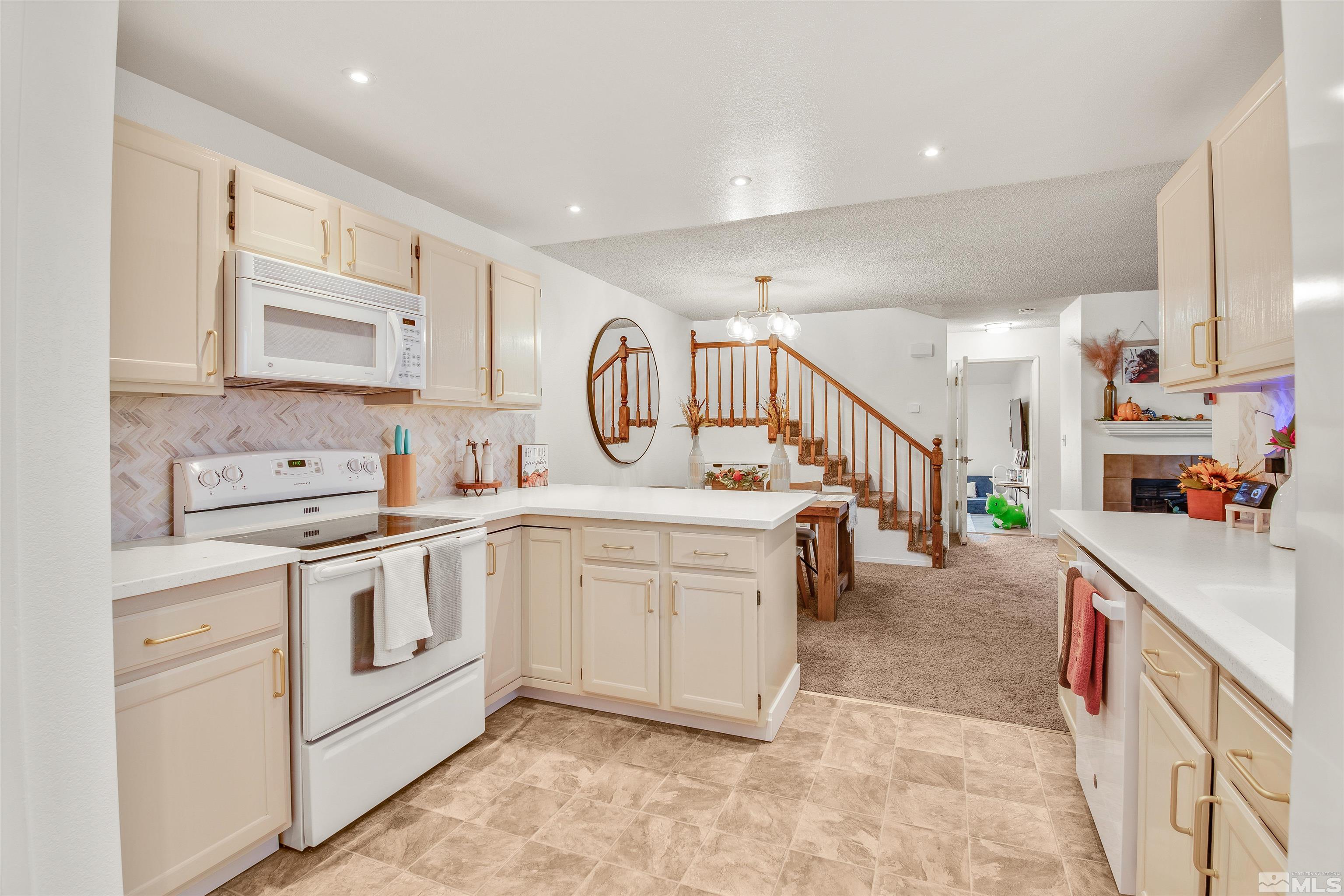 a large white kitchen with stainless steel appliances