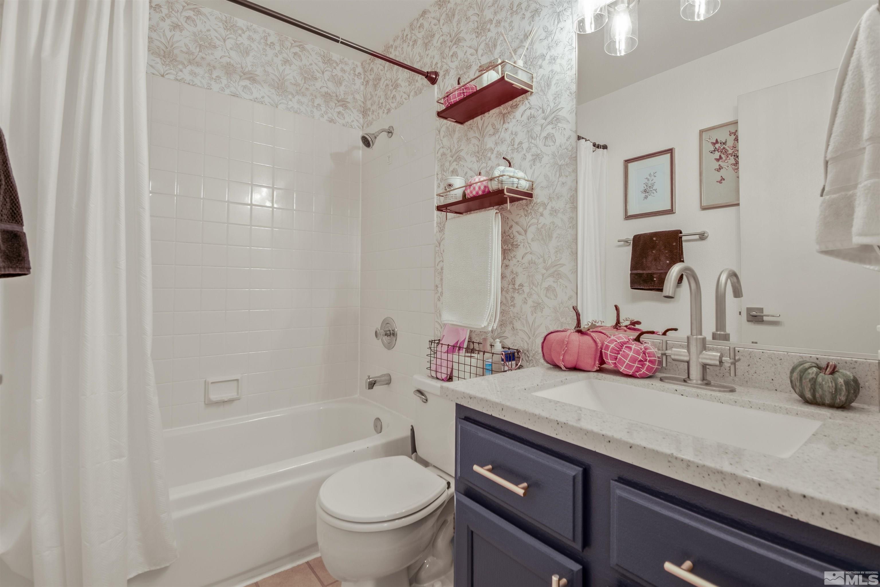 3961 Kings Row Reno, NV 89503 - Photo 13 of 25 a bathroom with a sink a toilet and shower
