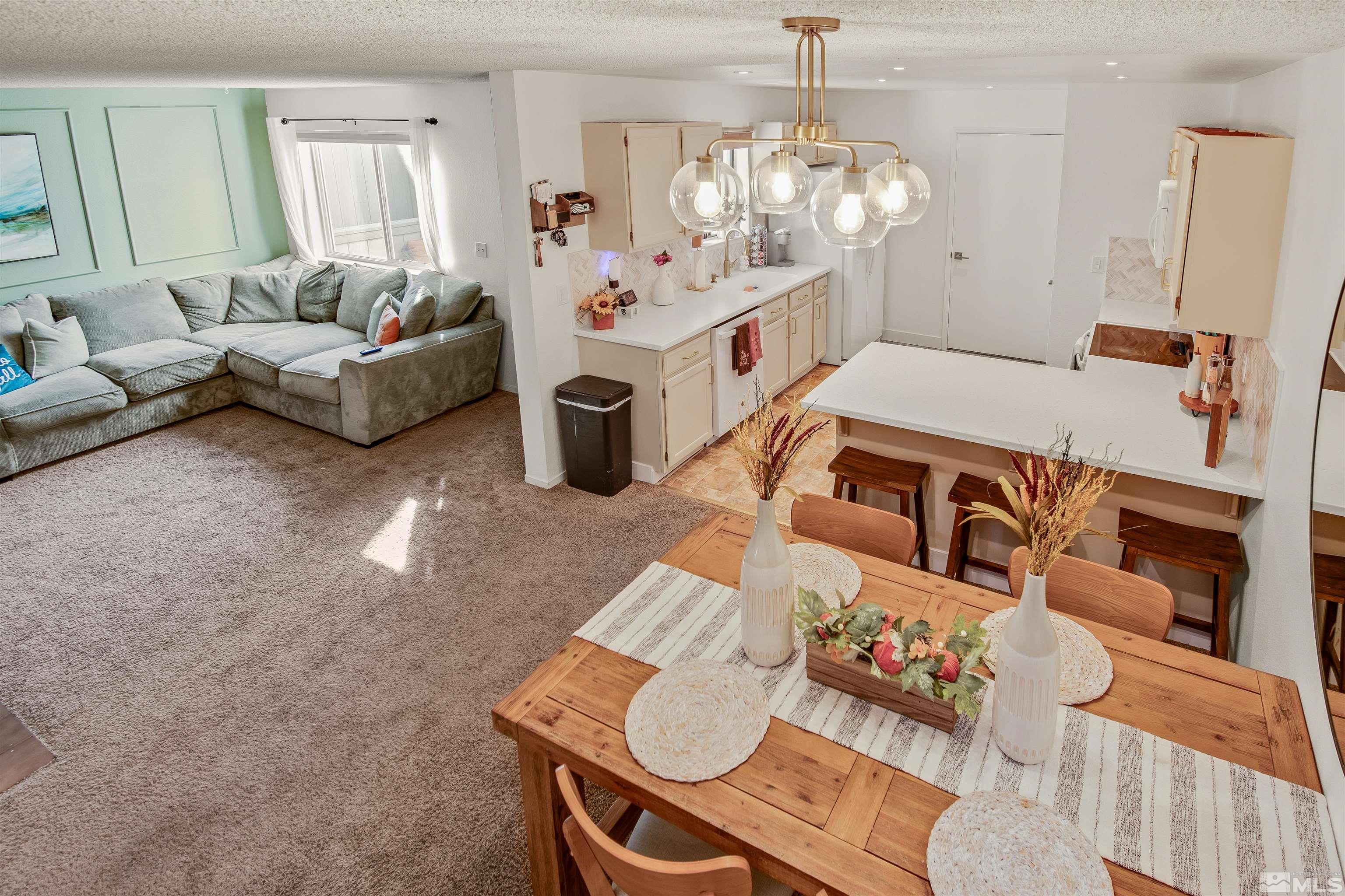 3961 Kings Row Reno, NV 89503 - Photo 14 of 25 a living room with furniture and a chandelier