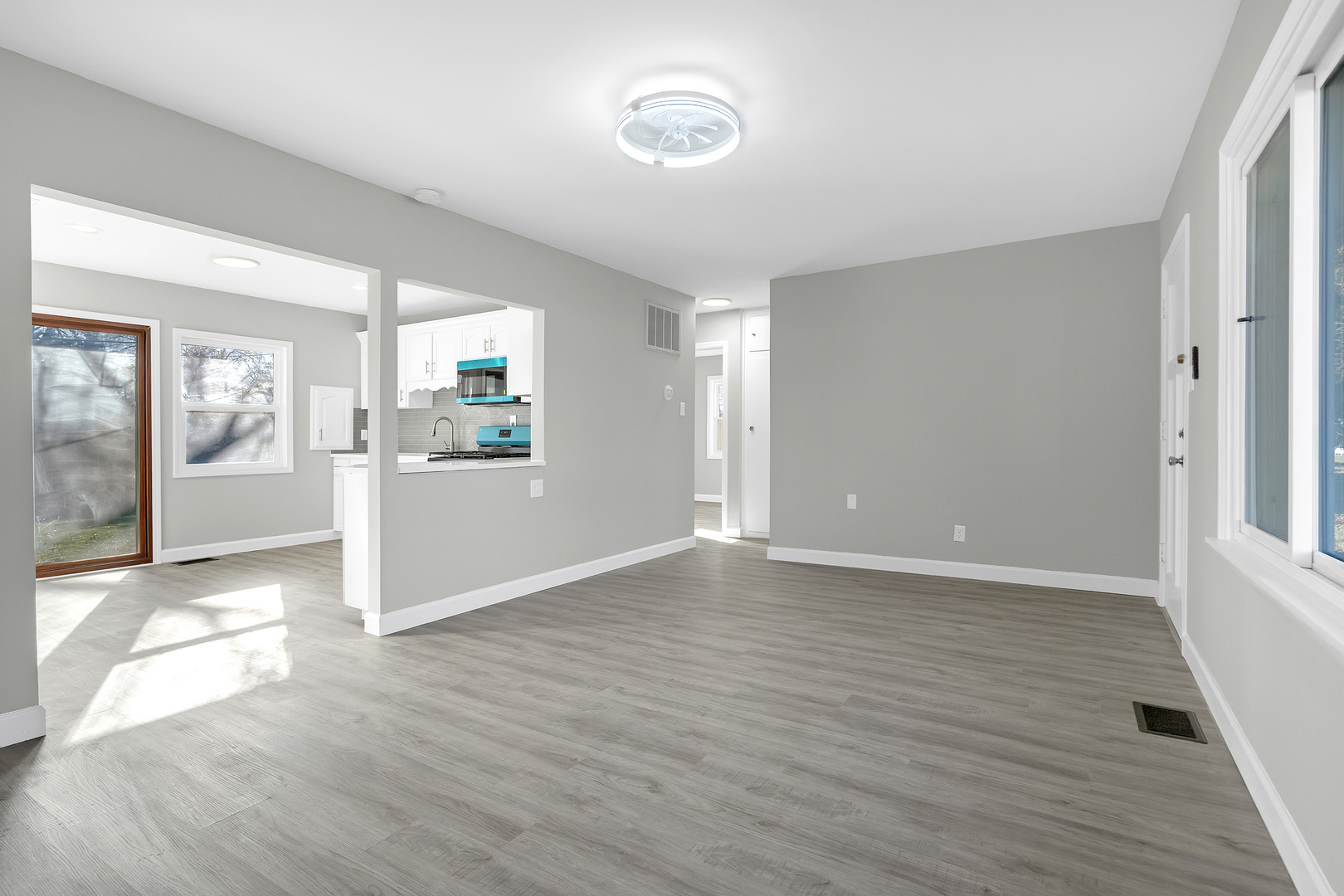104 Louis Road Joliet, IL 60433 - Photo 4 of 11 an empty room with wooden floor and windows