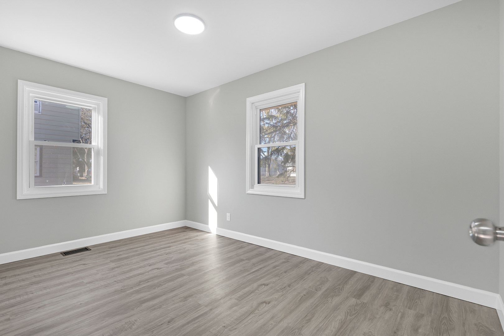 104 Louis Road Joliet, IL 60433 - Photo 9 of 11 a view of an empty room with wooden floor and a window