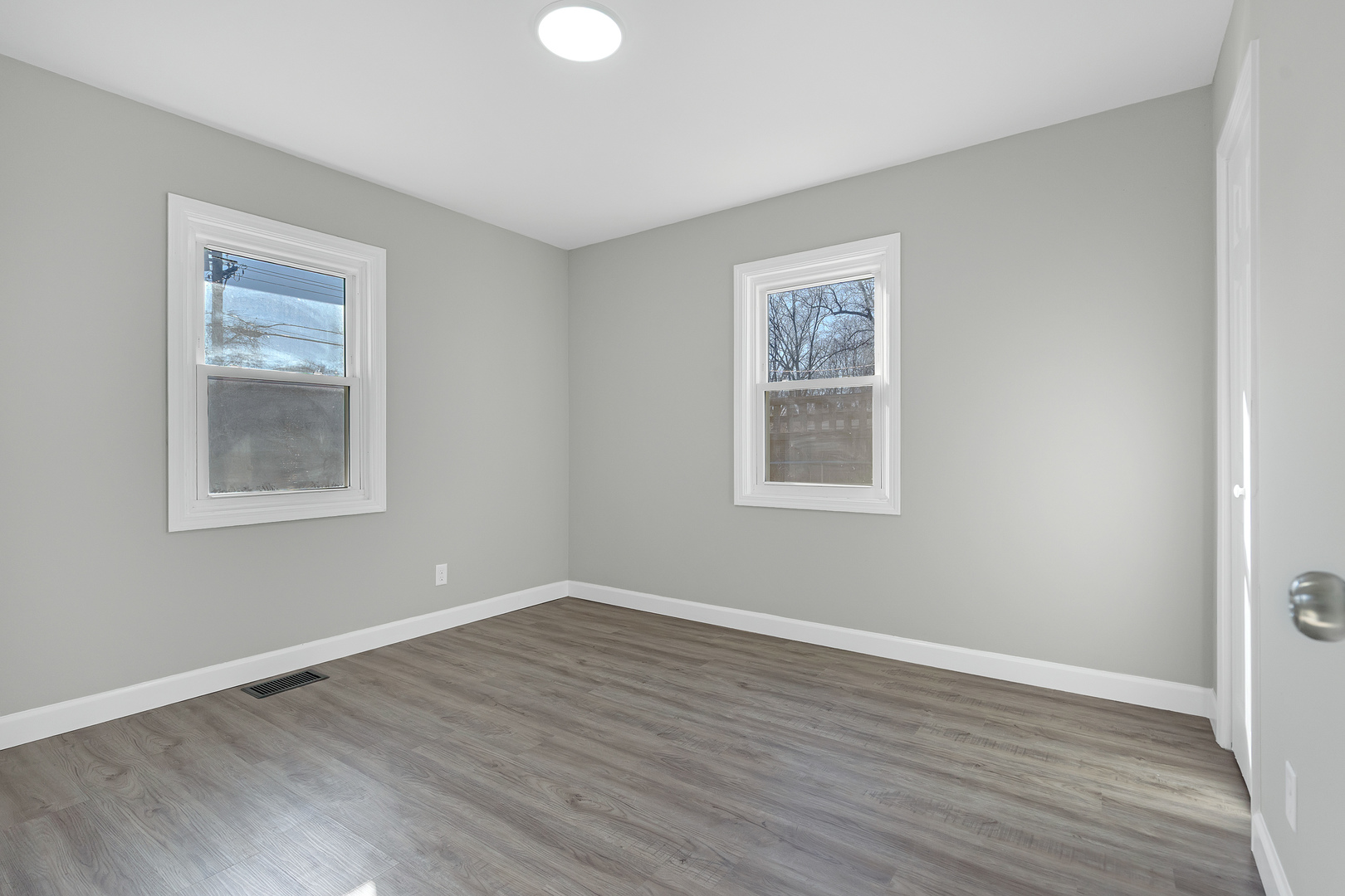 104 Louis Road Joliet, IL 60433 - Photo 10 of 11 a view of an empty room with wooden floor and a window