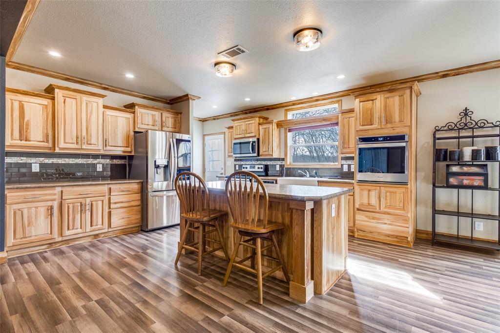 1425 Cowan Road Weston, TX 75009 - Photo 11 of 27 Kitchen with lots of built in cabinets and crown molding