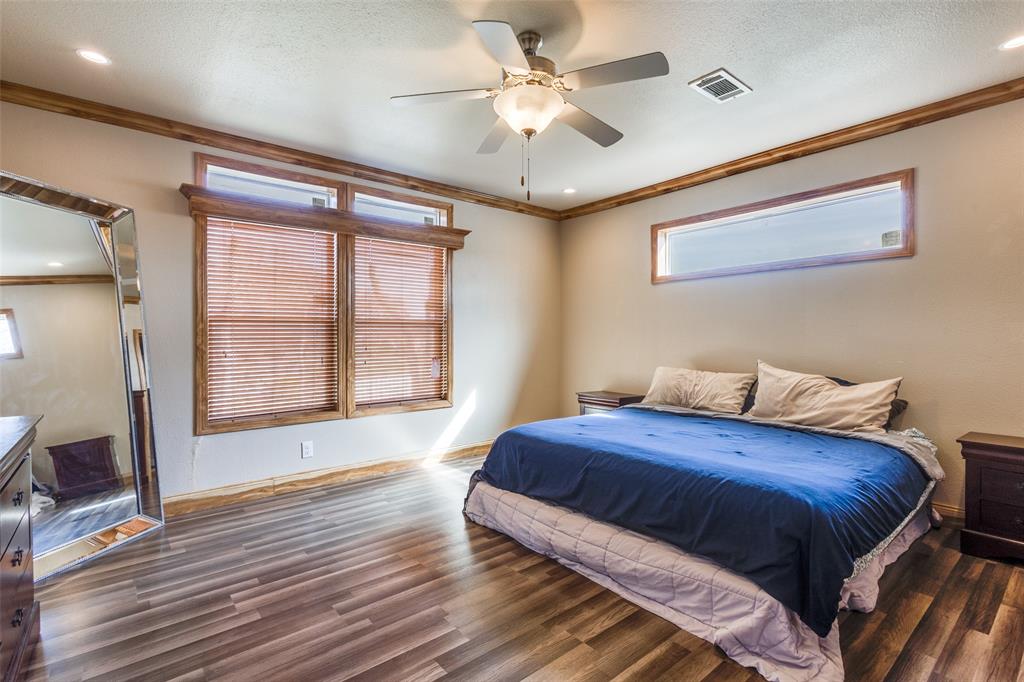 1425 Cowan Road Weston, TX 75009 - Photo 15 of 27 Primary bedroom with lots of windows, ceiling fan, and crown molding.