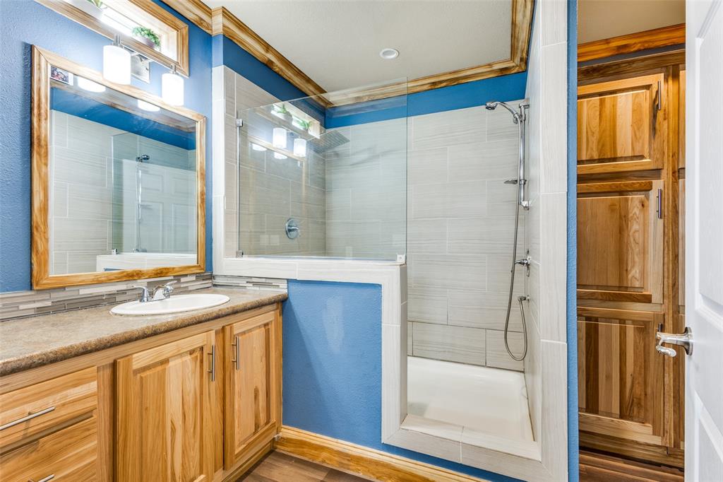 1425 Cowan Road Weston, TX 75009 - Photo 17 of 27 Primary bathroom with oversized shower, stained crown molding and lots of storage.