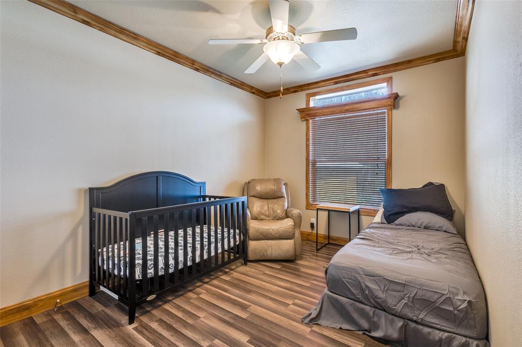 1425 Cowan Road Weston, TX 75009 - Photo 19 of 27 Secondary bedroom with crown molding a ceiling fan.