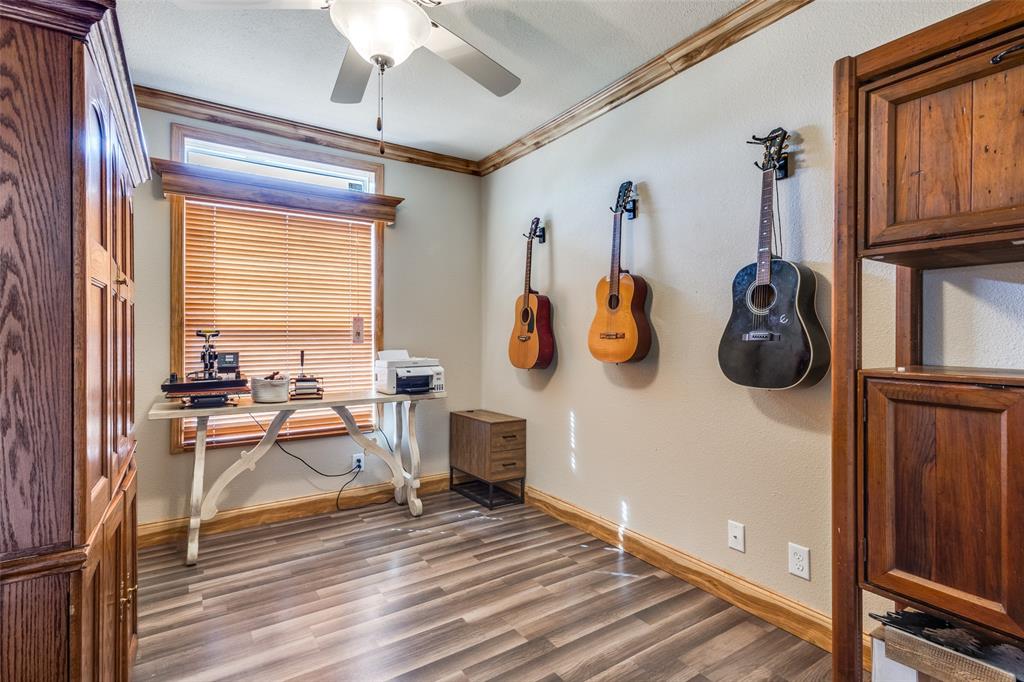 1425 Cowan Road Weston, TX 75009 - Photo 20 of 27 Bedroom with stained crown molding and base boards and decorative valence over blinds.