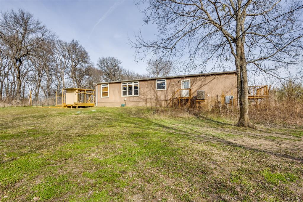 1425 Cowan Road Weston, TX 75009 - Photo 23 of 27 Back of home with wood deck and mature trees