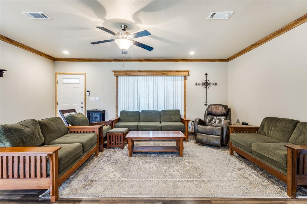 1425 Cowan Road Weston, TX 75009 - Photo 5 of 27 Large family room with crown molding and a ceiling fan.