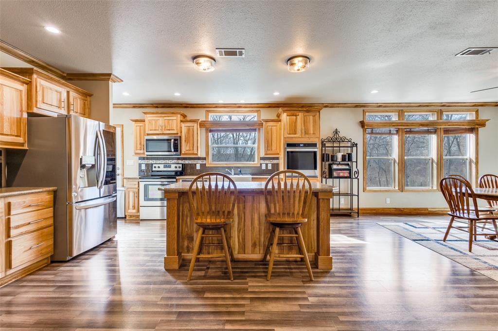 1425 Cowan Road Weston, TX 75009 - Photo 9 of 27 Kitchen with electric smoothtop range, stainless steel dishwasher, built in oven and a nice breakfast island.