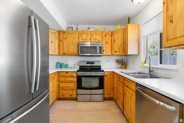 732 North 200 E Street Springville, UT 84663 - Photo 4 of 36 U-shaped kitchen featuring light wood cabinetry, white countertops, and stainless steel appliances including a refrigerator, range, microwave, and dishwasher