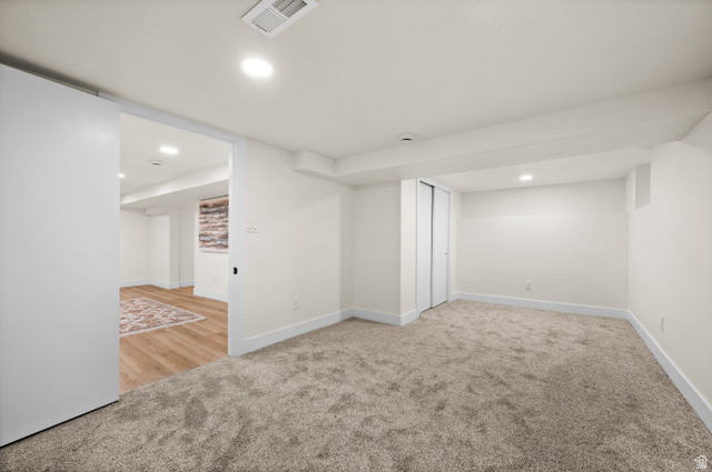 189 West Center Street Midvale, UT 84047 - Photo 33 of 64 Carpeted room with recessed lighting and white walls, featuring a bypass closet and wide white baseboards