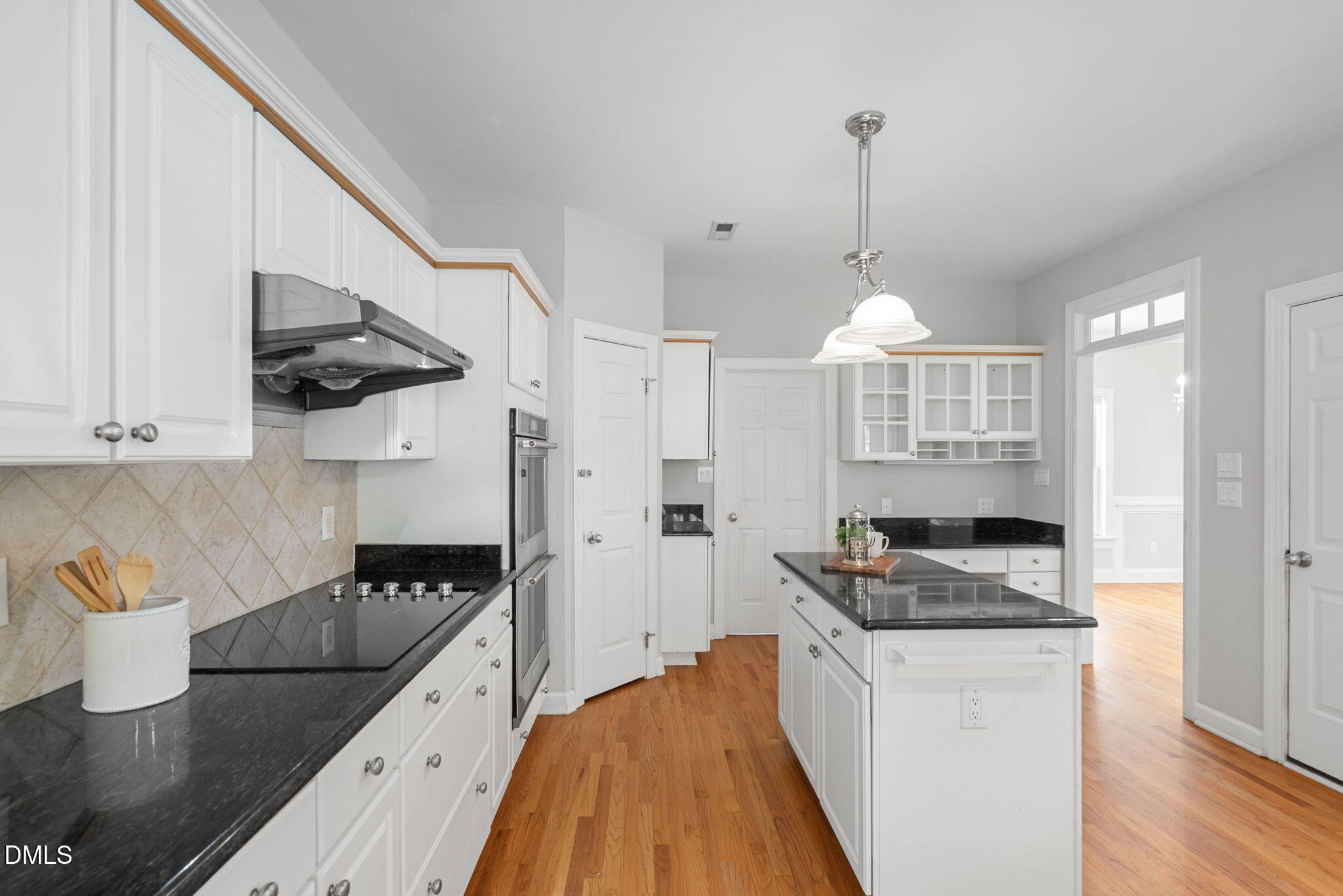 9916 Bonsal Crossing Road New Hill, NC 27562 - Photo 15 of 80 a kitchen with granite countertop a stove sink and cabinets