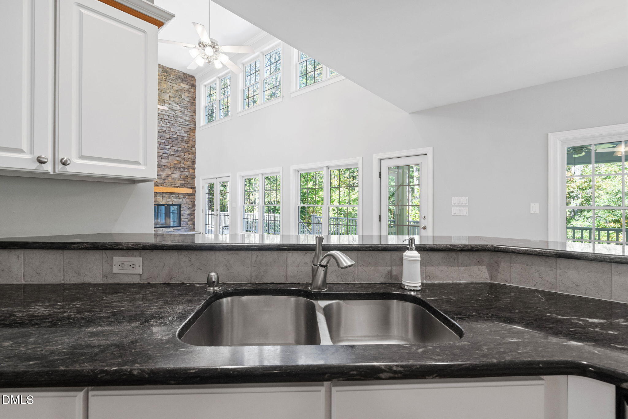 9916 Bonsal Crossing Road New Hill, NC 27562 - Photo 16 of 80 a kitchen with granite countertop a sink and a window