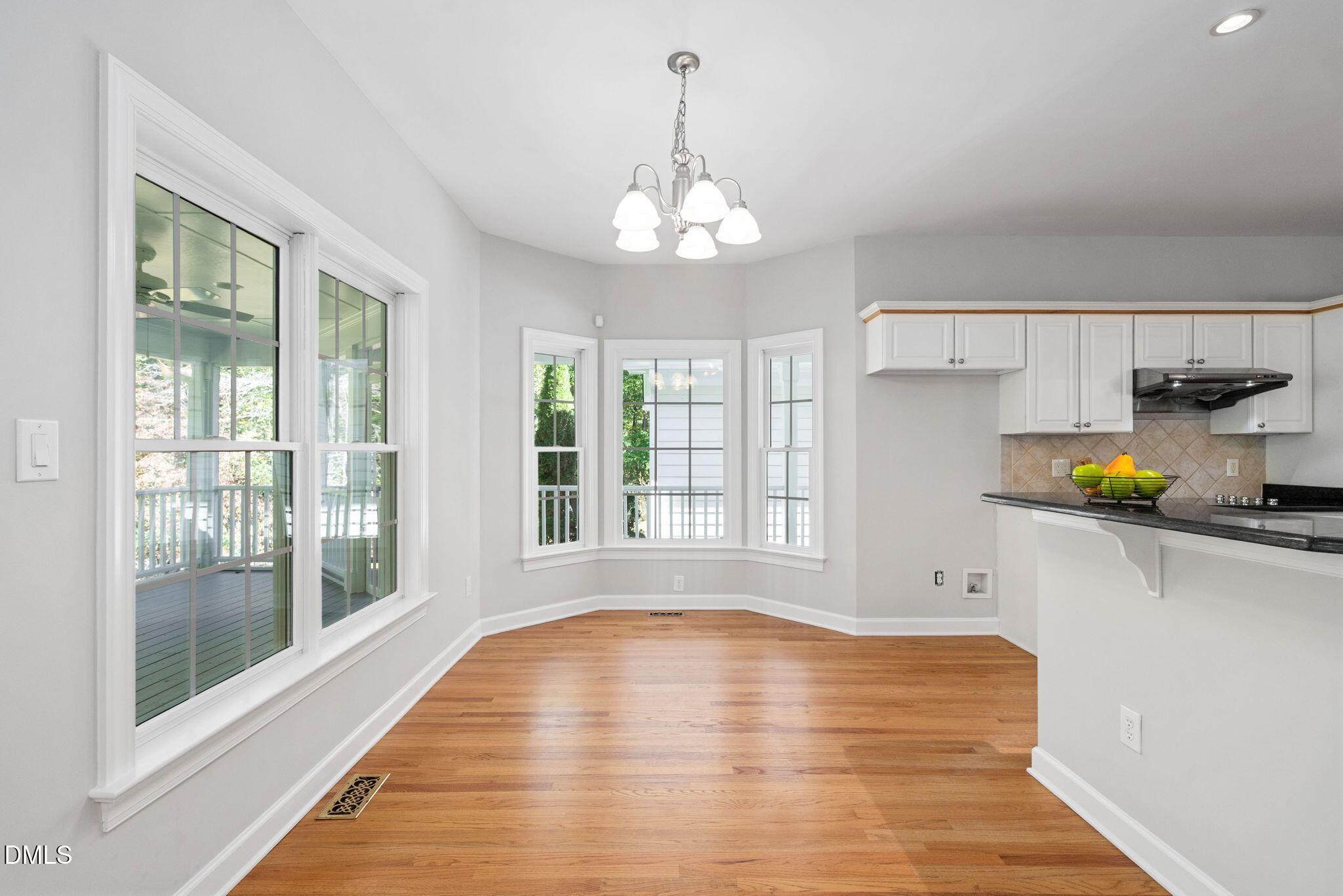 9916 Bonsal Crossing Road New Hill, NC 27562 - Photo 18 of 80 a view of an empty room with a window and wooden floor