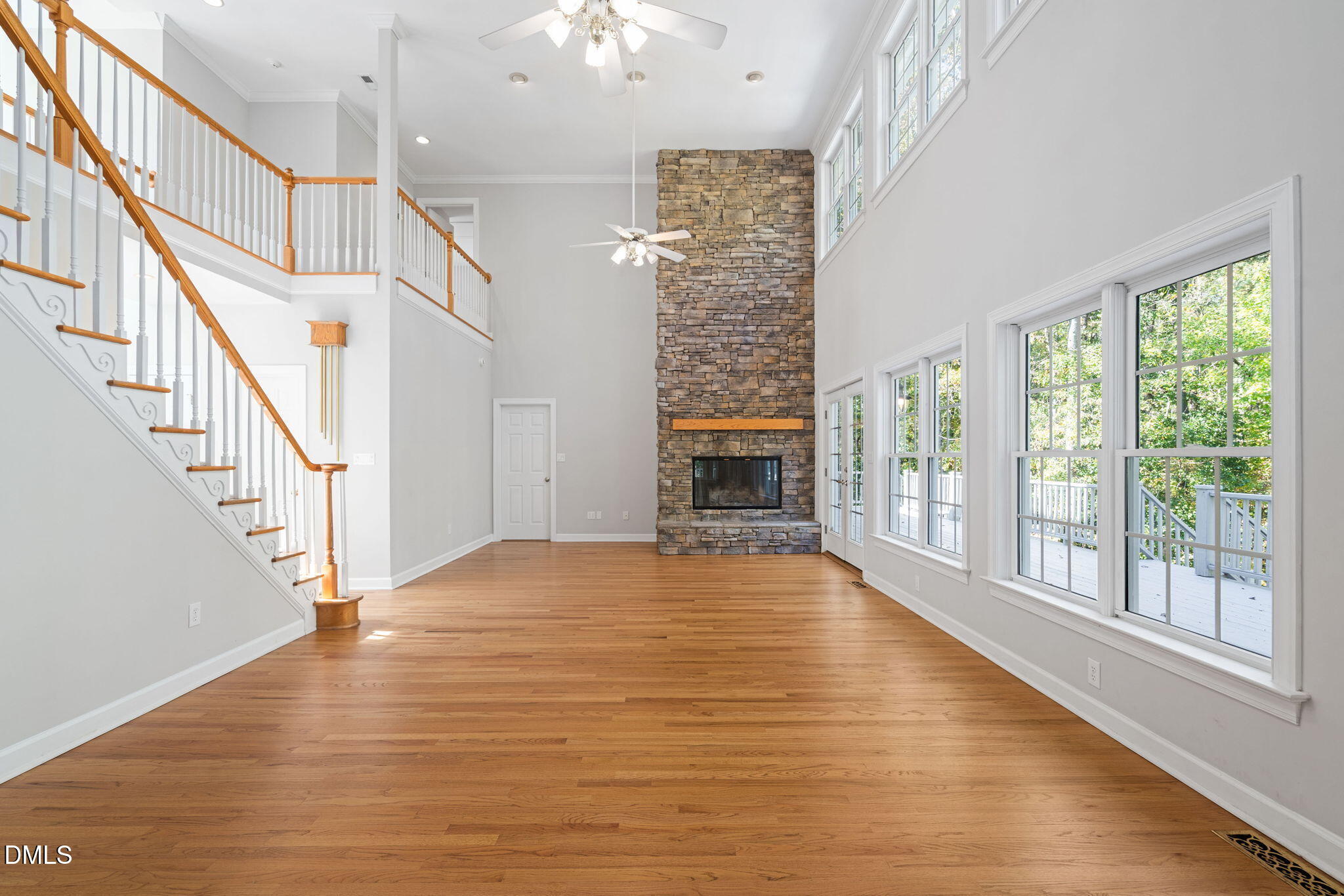 9916 Bonsal Crossing Road New Hill, NC 27562 - Photo 20 of 80 a view of an empty room with wooden floor and a window
