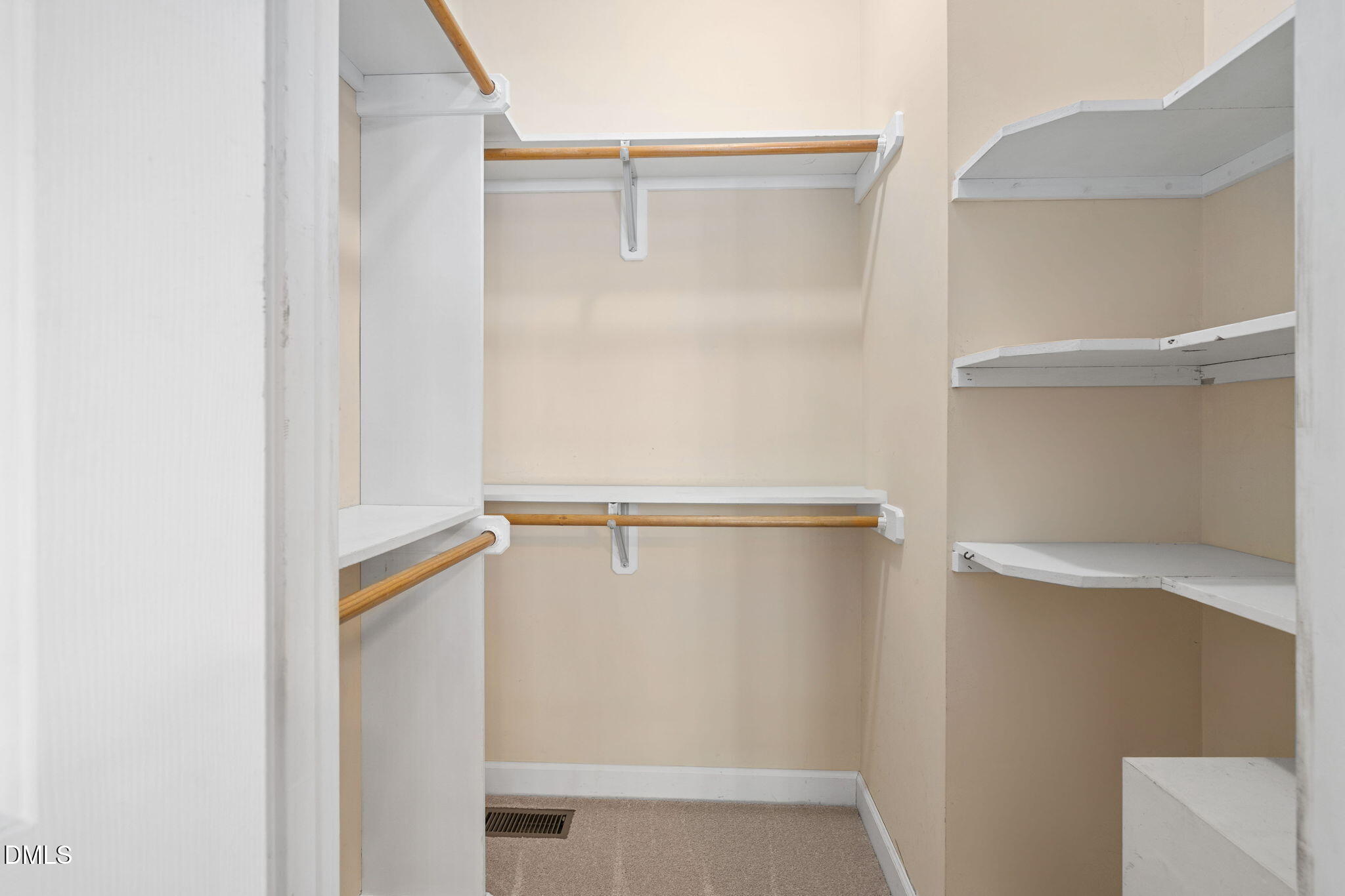 9916 Bonsal Crossing Road New Hill, NC 27562 - Photo 28 of 80 a view of walk in closet with empty racks