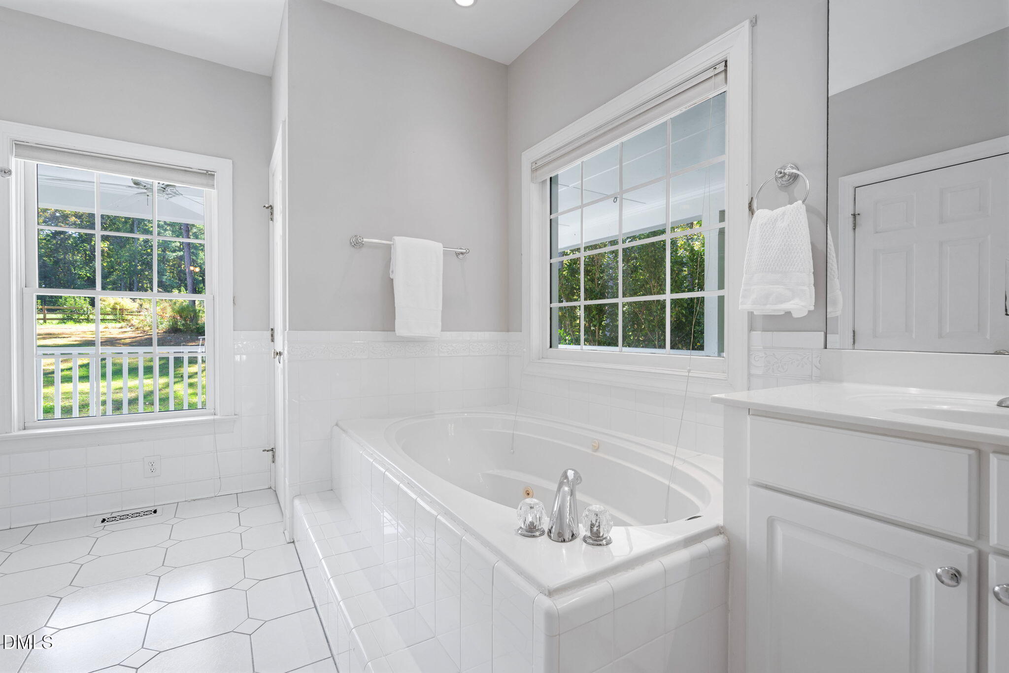 9916 Bonsal Crossing Road New Hill, NC 27562 - Photo 30 of 80 a bathroom with a sink and a bathtub