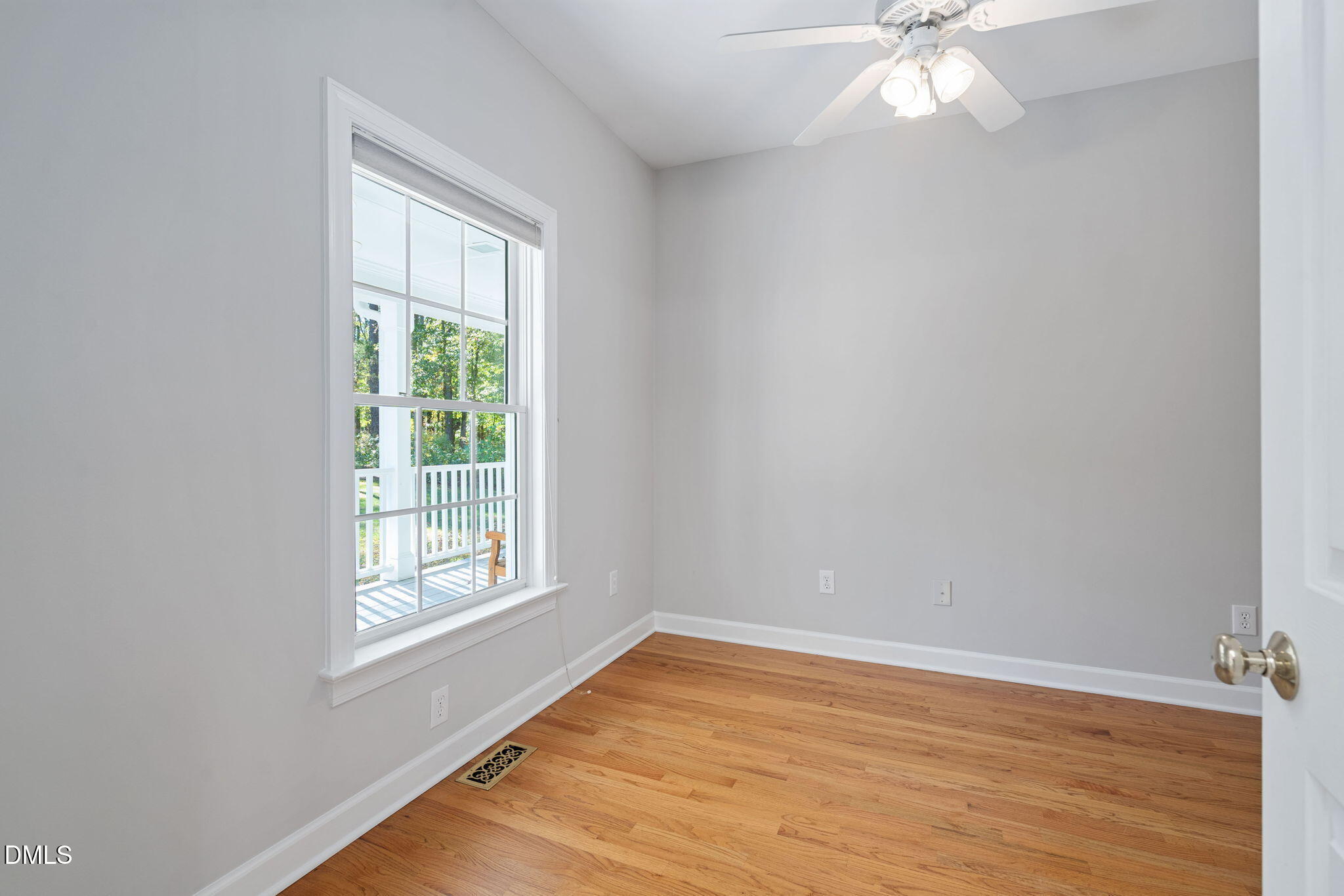 9916 Bonsal Crossing Road New Hill, NC 27562 - Photo 33 of 80 an empty room with wooden floor and windows