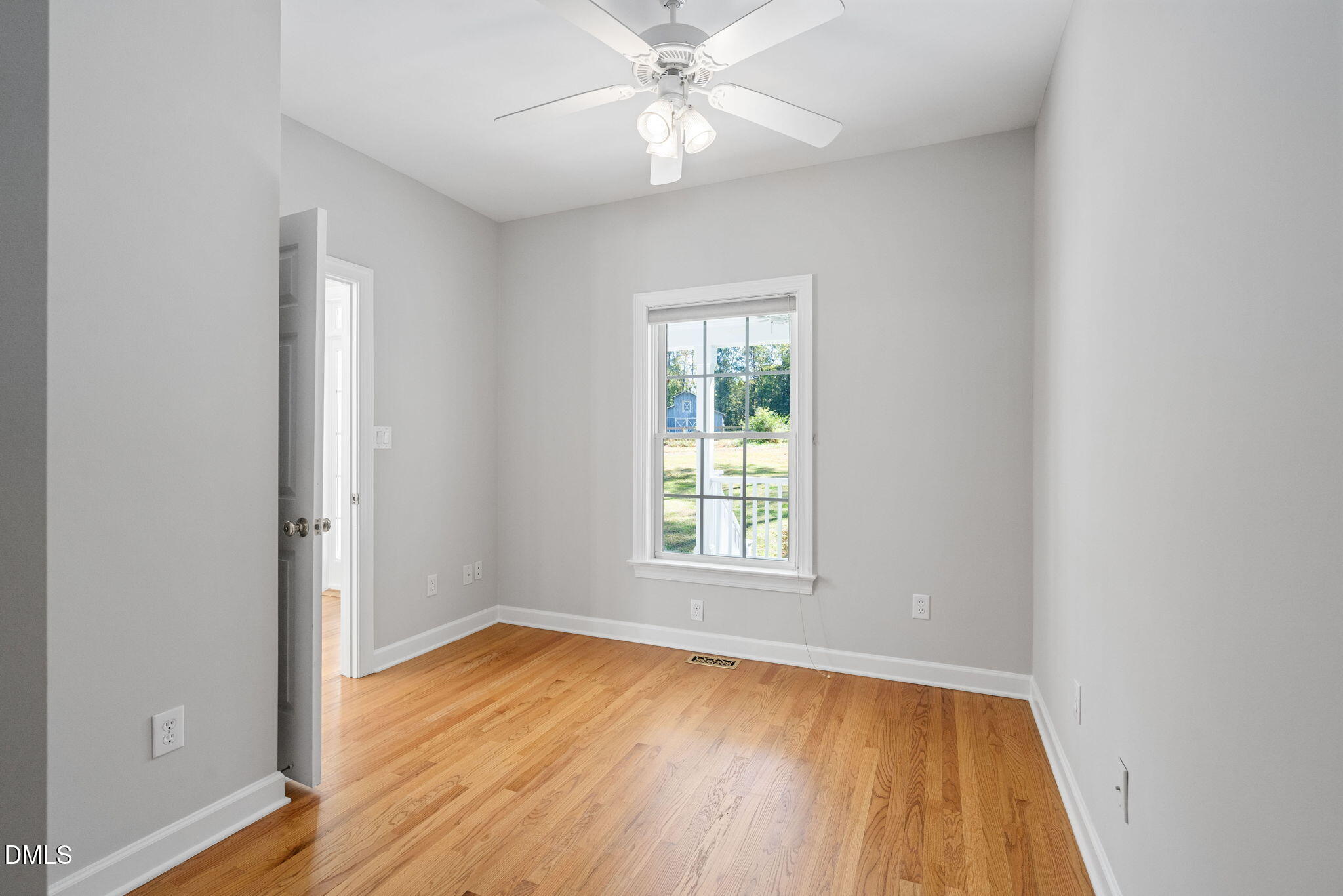 9916 Bonsal Crossing Road New Hill, NC 27562 - Photo 34 of 80 an empty room with wooden floor closet and windows