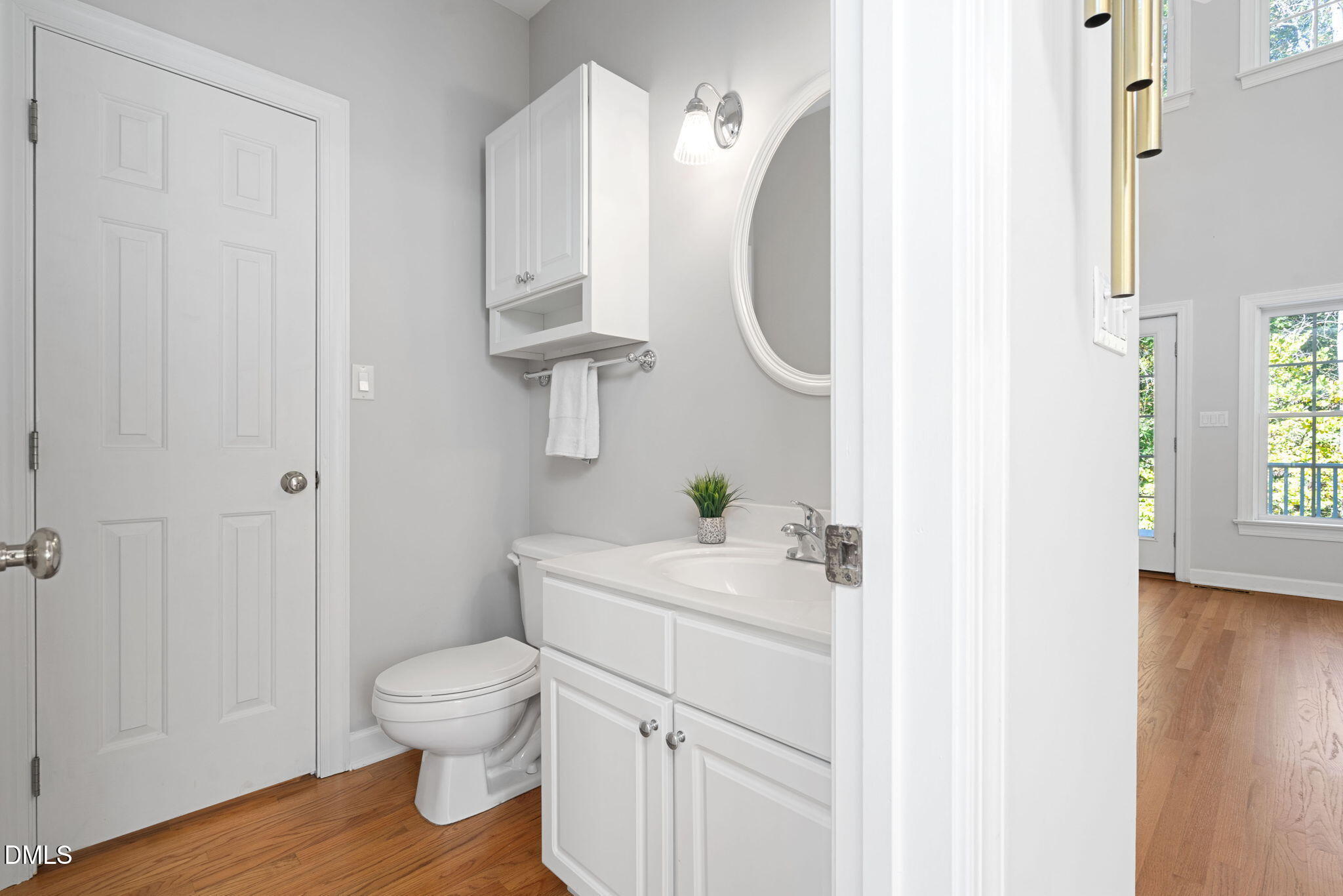 9916 Bonsal Crossing Road New Hill, NC 27562 - Photo 35 of 80 a bathroom with a sink a toilet and a mirror