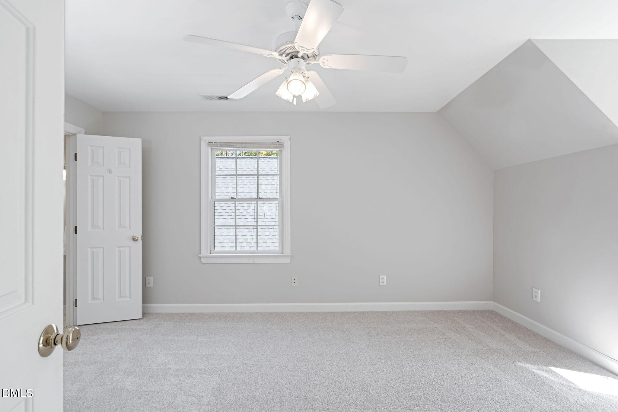 9916 Bonsal Crossing Road New Hill, NC 27562 - Photo 39 of 80 an empty room with windows and ceiling fan