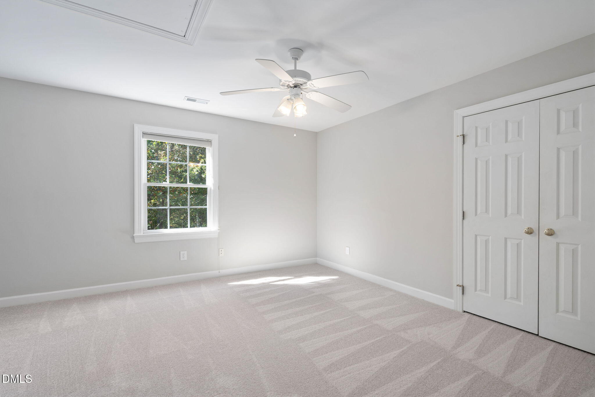 9916 Bonsal Crossing Road New Hill, NC 27562 - Photo 43 of 80 an empty room with windows and fan